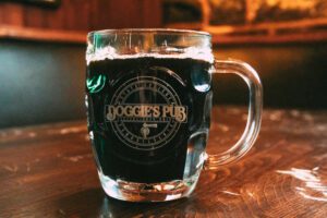 A Glass Mug With Beverage and Doggies Pub Printed One