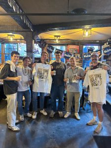 A group of Doggie's patrons holding Modelo promotional items